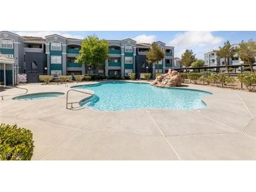 Relaxing community pool with a waterfall feature for residents to enjoy on warm days at 6955 N Durango Dr # 2031, Las Vegas, NV 89149