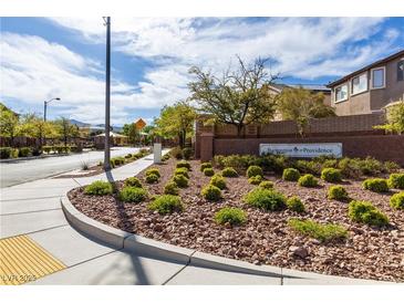Inviting Barrington at Providence community entrance with lush landscaping and clear signage on a sunny day at 7237 Puddle Duck St, Las Vegas, NV 89166
