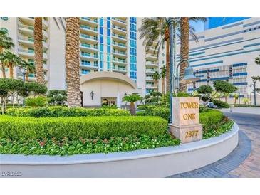 Landscaped entrance with Tower One signage, lush green bushes, and tropical palm trees on a sunny day at 2877 Paradise Rd # 2502, Las Vegas, NV 89109