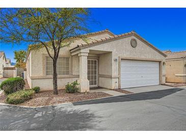 Charming single-story home with a two-car garage, mature tree, and neutral-toned stucco exterior at 5114 Mascaro Dr, Las Vegas, NV 89122