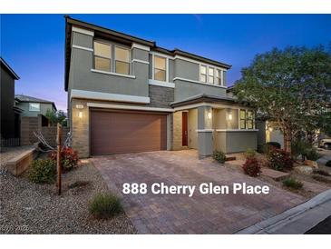 Inviting two-story home featuring a brick driveway, neutral color scheme, and manicured landscaping at 888 Cherry Glen Pl, Las Vegas, NV 89138