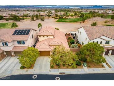 Spacious two-story home featuring a red tile roof, well-manicured yard, and a view of the golf course at 1172 Via Della Costrella, Henderson, NV 89011