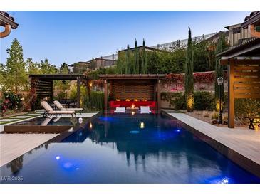 Inviting backyard pool area with comfortable seating and lush landscaping, perfect for relaxation and entertaining at 12119 Castilla Rain Ave, Las Vegas, NV 89138