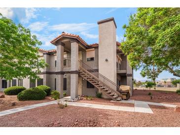 Exterior view of charming two-story condo with red rock landscaping at 1575 W Warm Springs Rd # 121, Henderson, NV 89014