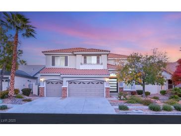 Charming two-story home featuring a three-car garage and manicured front yard with mature landscaping at 2236 Timber Rose Dr, Las Vegas, NV 89134