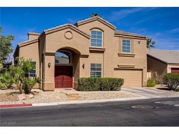 Charming two-story home featuring a neutral stucco facade and a well-manicured front yard at 3420 Lockport St, Las Vegas, NV 89129