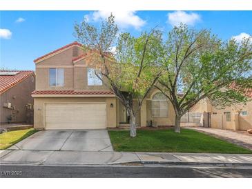 Two-story home featuring a two-car garage, neutral colored exterior, and a well-maintained lawn at 421 Raindance Dr, Henderson, NV 89014