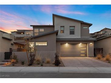Contemporary two-story home featuring desert landscaping, modern garage door, and neutral color palette at 461 Cascade Heights Ave, Las Vegas, NV 89138