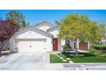 Charming single-story home with a well-manicured lawn and a two car garage at 5000 Charlo Dr, Las Vegas, NV 89131
