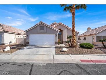 Charming single-story home featuring desert landscaping, a two-car garage, and a welcoming front entrance at 5244 Velazco Ln, Las Vegas, NV 89130