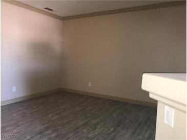 This living room offers a spacious area and attractive wood-look floors for a modern design at 5525 W Flamingo Rd # 2037, Las Vegas, NV 89103
