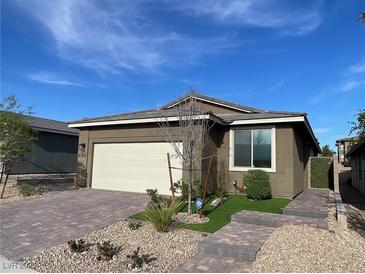 Charming single-story home showcasing an attached two-car garage and low-maintenance landscaping in front at 6756 Millbury St, North Las Vegas, NV 89086