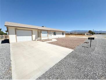 Ranch style home with a two-car garage and low maintenance landscaping at 810 E Calvada Blvd, Pahrump, NV 89048