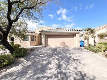 Charming single-story home featuring a tile roof, paver driveway, and well-maintained landscaping at 8161 Cane Creek Mill Ct, Las Vegas, NV 89131