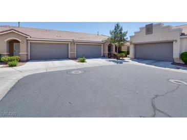 Charming single-story home featuring a tile roof, well-maintained landscaping, and a two-car garage at 8524 Little Fox St, Las Vegas, NV 89123