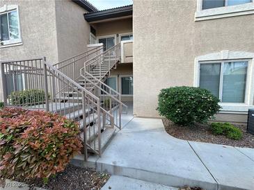 Condo complex with stairs leading to units with well-kept landscaping at 8985 S Durango Dr # 1034, Las Vegas, NV 89113