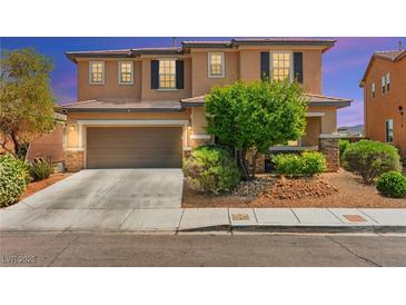Charming two-story home with a two-car garage and well-maintained landscaping at 9588 Vital Crest St, Las Vegas, NV 89123