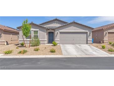 Charming single-story home featuring a two-car garage and low maintenance desert landscaping at 456 Desoto Falls St, Indian Springs, NV 89018