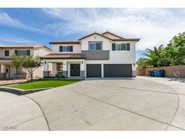 Two story home with a three car garage and a well manicured lawn at 1223 Starstone Ct, Henderson, NV 89014