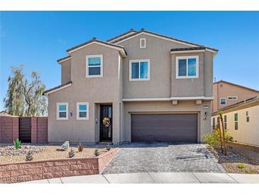 Charming two-story home with a well-manicured yard, desert landscaping, and a two-car garage at 2127 Brewer Ave, North Las Vegas, NV 89081