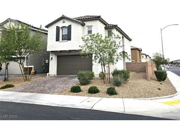 Charming two-story home features a brown garage door and desert landscaping at 4109 Cloudless Ave, North Las Vegas, NV 89081
