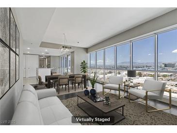 Bright living room featuring modern furniture, large windows and city views at 4575 Dean Martin Dr # 1208, Las Vegas, NV 89103