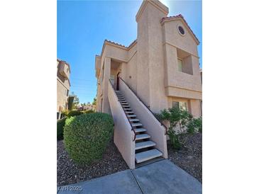 Inviting condominium featuring a private entrance, a stairway and desert landscaping at 5225 W Reno Ave # 210, Las Vegas, NV 89118