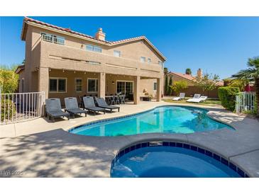 Inviting backyard pool and spa with lounge chairs and covered patio, perfect for outdoor entertaining at 723 Seclusion Glen Ave, Las Vegas, NV 89123