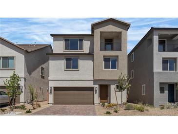 Charming two-story home featuring a balcony, a two-car garage, and meticulous landscaping, adding curb appeal to this lovely residence at 7482 Lodano Ave, Las Vegas, NV 89113