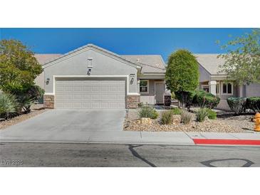 Charming single-story home featuring a well-manicured front yard and two-car garage at 7732 Songster St, North Las Vegas, NV 89084