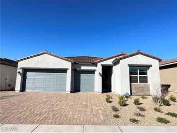 Charming single-story home with a well-maintained front yard and a three-car garage at 80 Brixton Ave, Henderson, NV 89011