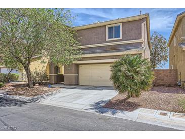 Charming two-story home featuring desert landscaping, attached two car garage, and a welcoming front entrance at 8084 Celina Hills St, Las Vegas, NV 89131