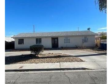 Charming single-story home featuring neutral paint, mature landscaping, and a spacious front yard at 893 Laramore Dr, Las Vegas, NV 89119