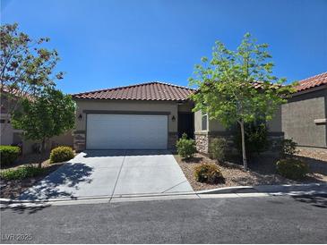 Charming single-story home featuring a tile roof, stone accents, and a well-maintained front yard at 9463 Jumping Frog Ct, Las Vegas, NV 89147