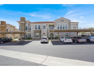Condo exterior showcases ample parking and a well-maintained building with covered parking spaces at 10001 Peace Way # 2277, Las Vegas, NV 89147