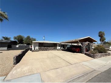Charming single-story home featuring a large driveway and covered parking at 1674 Seneca Ln, Las Vegas, NV 89169