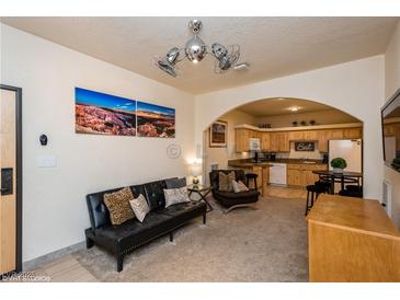 Inviting living room flows into an open kitchen with an archway and neutral decor at 223 Hunter Ridge Rd # 300, Brian Head, UT 84719