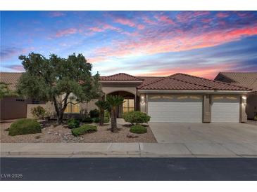 Beautiful single story home featuring a three car garage and desert landscaping at 2251 Summerwind Cir, Henderson, NV 89052
