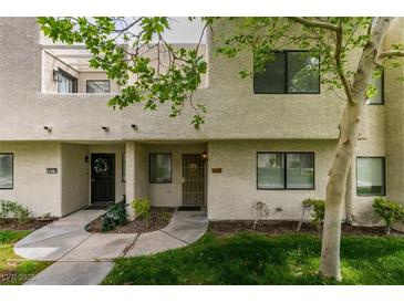 Inviting two-story townhouse with a well-maintained lawn and garden, plus a decorative wreath on the front door at 2681 Ruthe Duarte Ave, Las Vegas, NV 89121