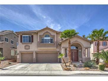 Inviting two-story home with a well-manicured lawn, mature palms, and a spacious three-car garage at 2749 Carolina Blue Ave, Henderson, NV 89052
