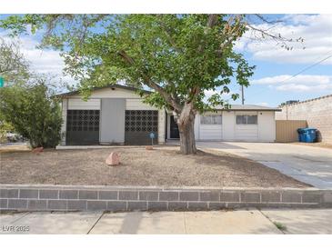 Charming single-story home featuring a well-maintained yard and a covered front porch entrance at 3017 Jamestown Way, Las Vegas, NV 89102