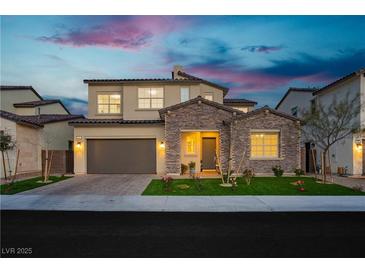 Stunning two-story home with stone accents, well-manicured lawn, and a two-car garage at 350 Gandara St, Las Vegas, NV 89138