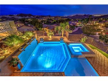 Gorgeous backyard pool and spa area with stunning city and mountain views at twilight at 47 Strada Principale, Henderson, NV 89011