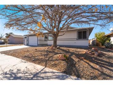 Cozy single-story home featuring xeriscape, mature tree providing shade, and an attached two car garage at 4981 Alondra Dr, Las Vegas, NV 89118