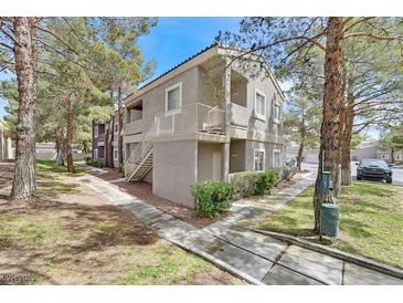 Attractive two-story condo building featuring a private balcony and nicely landscaped grounds at 5250 S Rainbow Blvd # 1144, Las Vegas, NV 89118