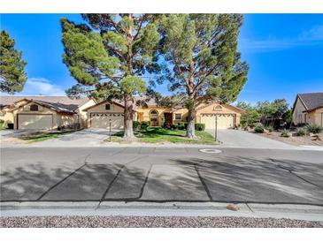Charming single-story home featuring mature trees, a well-maintained lawn, and a two-car garage at 5541 Port Barrington Way, Las Vegas, NV 89130