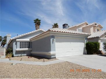 Charming one-story home with a two-car garage, desert landscaping, and a blue sky at 5912 Wabusca Way, Las Vegas, NV 89142