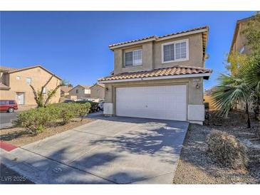 Charming two-story home features a two car garage, desert landscaping and tile roof at 5929 Sleepy Fawn Dr, Las Vegas, NV 89142
