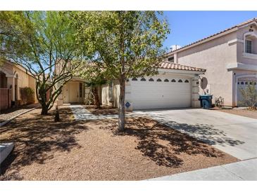 Charming single-story home featuring a well-maintained yard and a two-car garage at 7441 Aurora Glow St, Las Vegas, NV 89139
