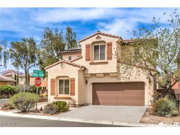 Charming two-story home with a tile roof, brown shutters, a two-car garage, and desert landscaping at 7898 Red Rock Ridge Ave, Las Vegas, NV 89179